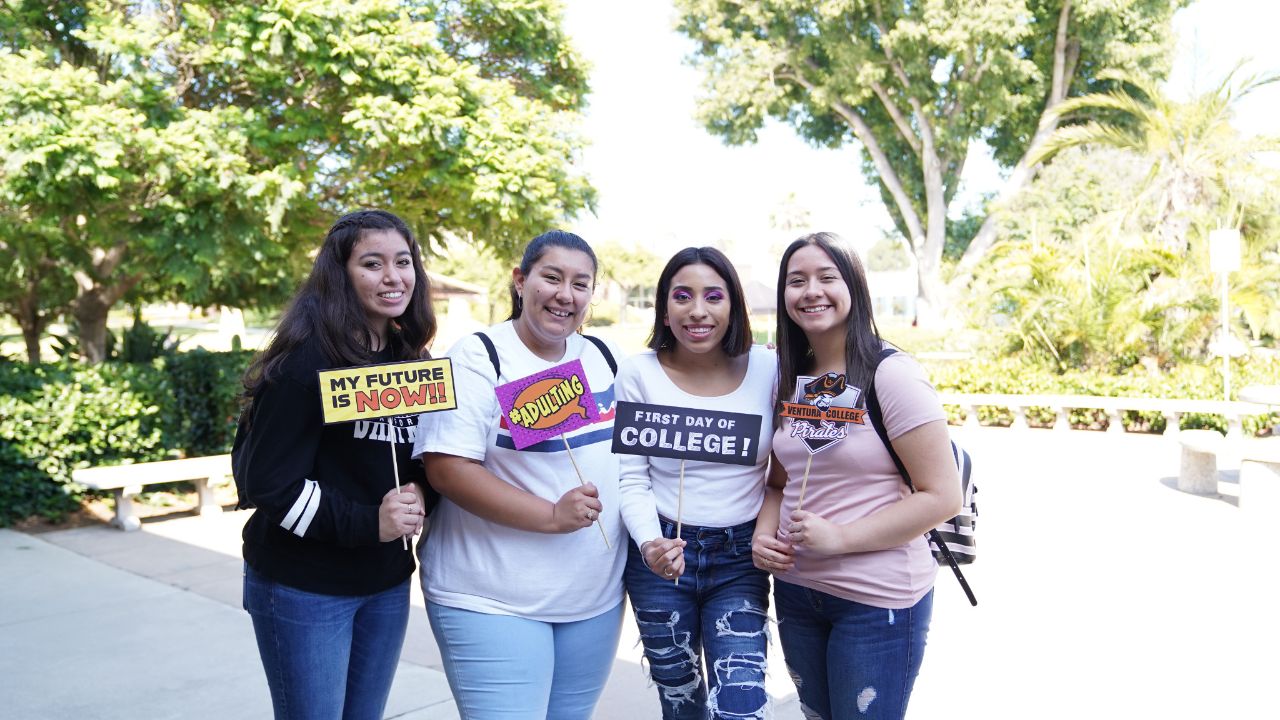 Group of students pose with college signs at FYE Expo
