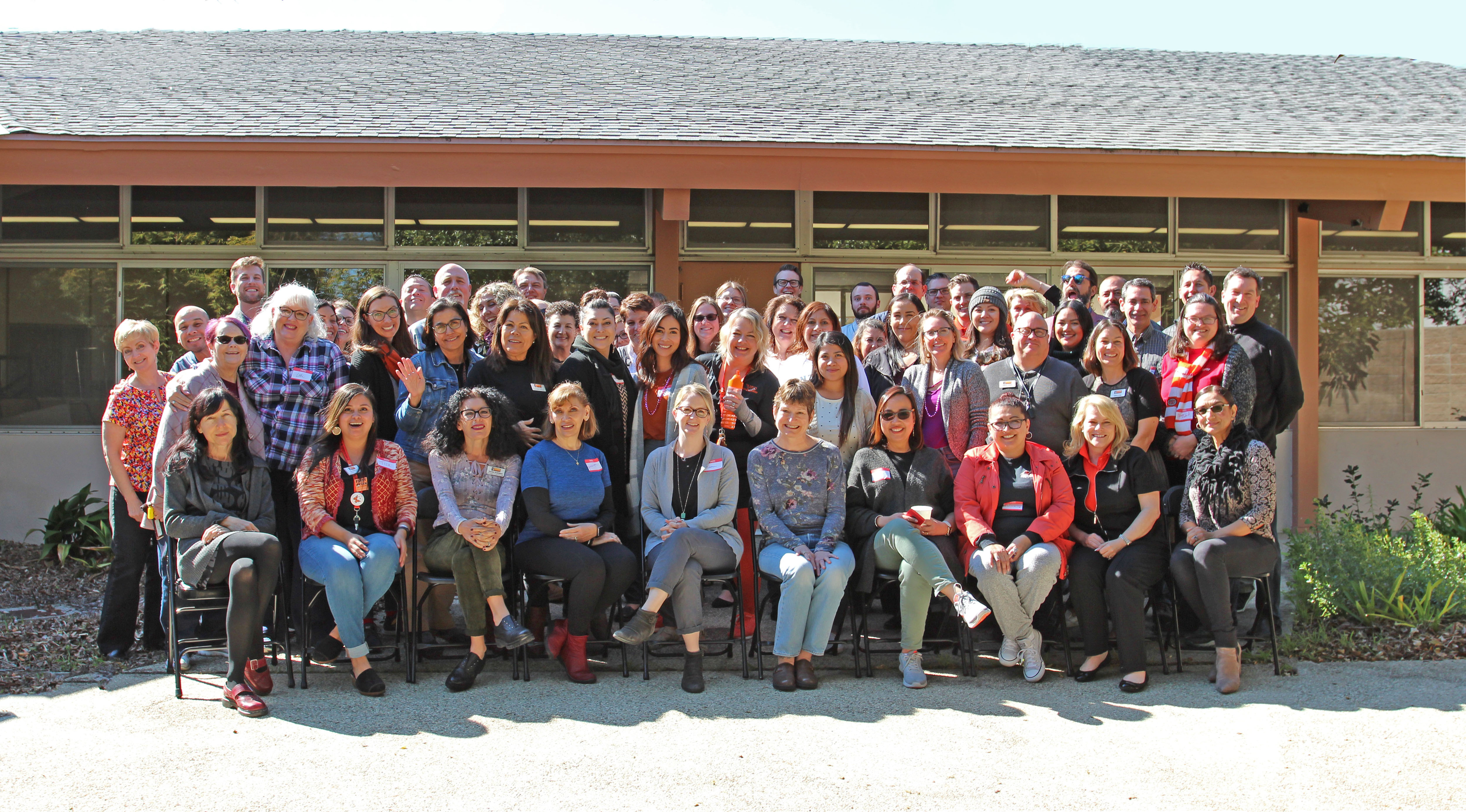 Group Photo of Ventura College staff at college wide even in the patio of Wright Event Center. The sun is shinning.