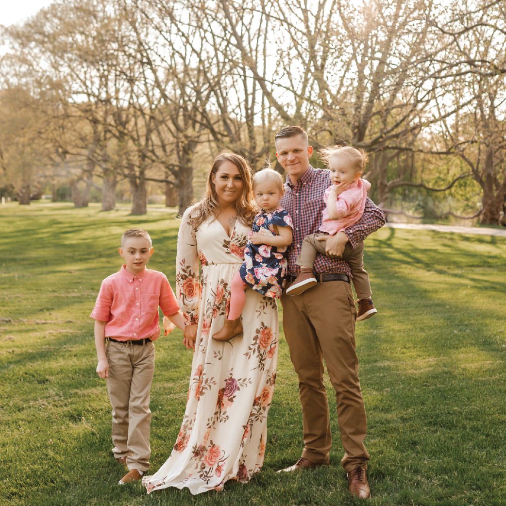 nichole vigliotti and her family standing in a grove of trees