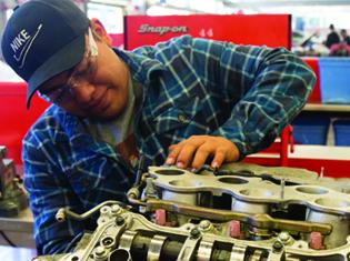 A student working on a car engine.