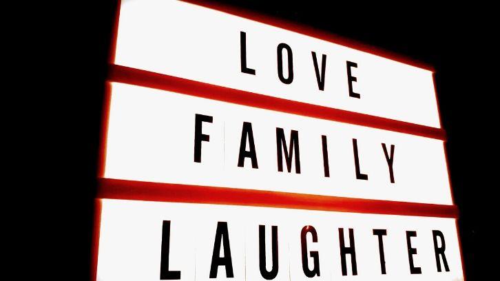 Red and white sign Love, Family, Laughter