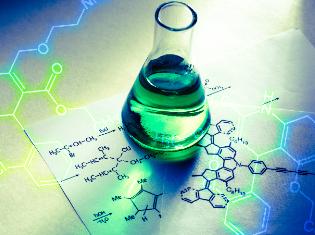 A beaker sitting on top of notes with a molecular diagram.