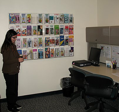 Photo of a student looking at a health brochure at the VC St