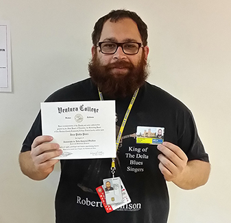 Photo of a student showing diploma