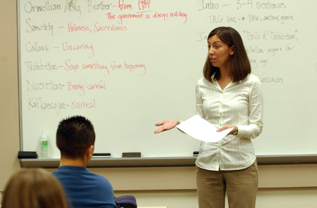 Instructor lecturing in front of class.