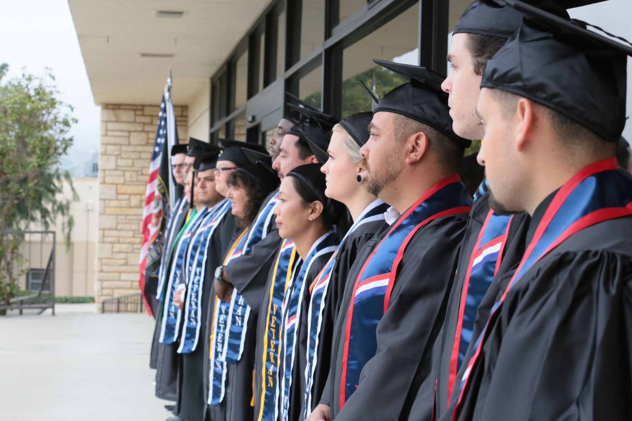 Students posing for a photo outside the VRC at graduation