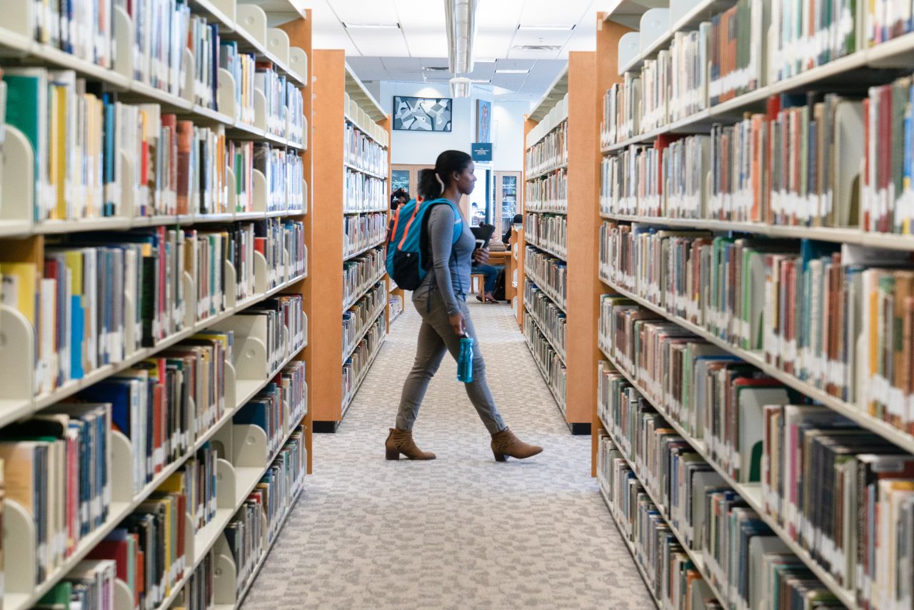 Student walks through Library