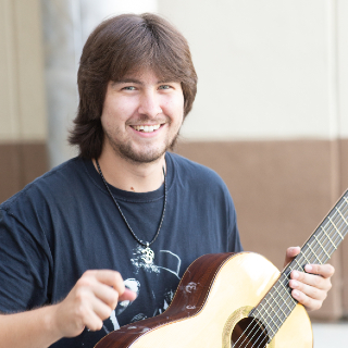 student playing a guitar