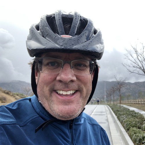 Matt Moore riding his bike in the rain