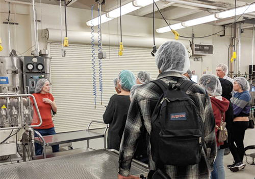 Instructor teaching students about food safety in a food facility