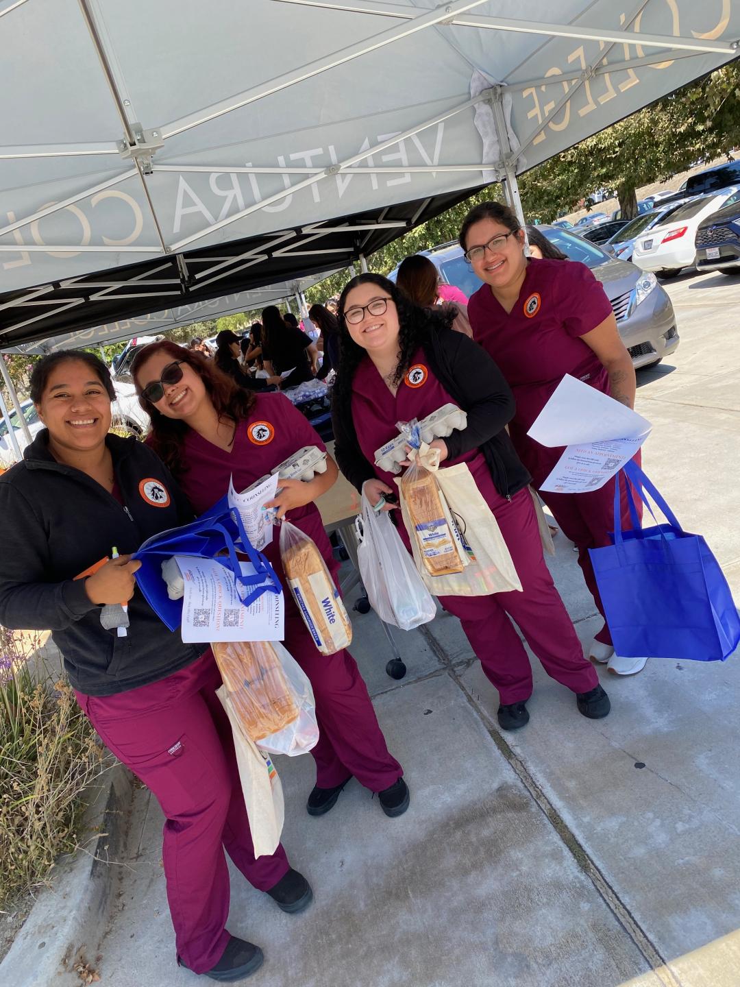 Vet Tech students holding their free groceries