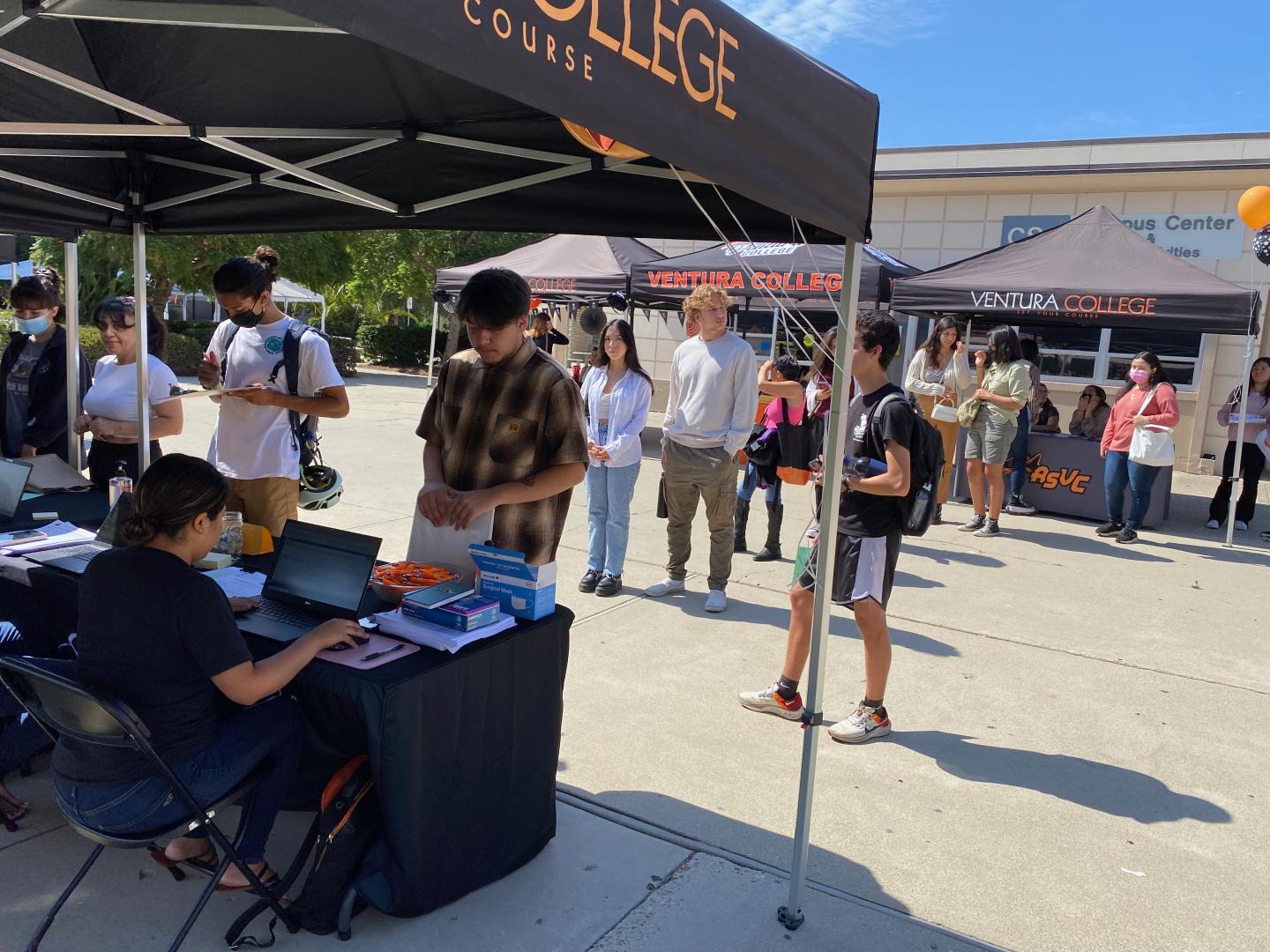 Tables and balloons set up with students visiting the FWS Job Fair