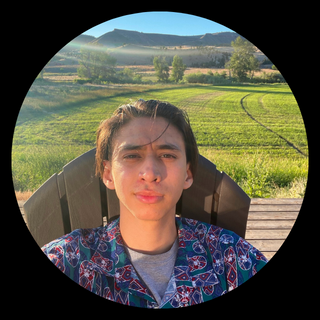 Student sitting in chair in front of mountains