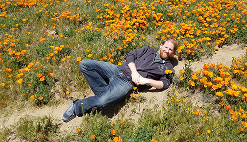 Professor Robert Pipal in a field of poppies
