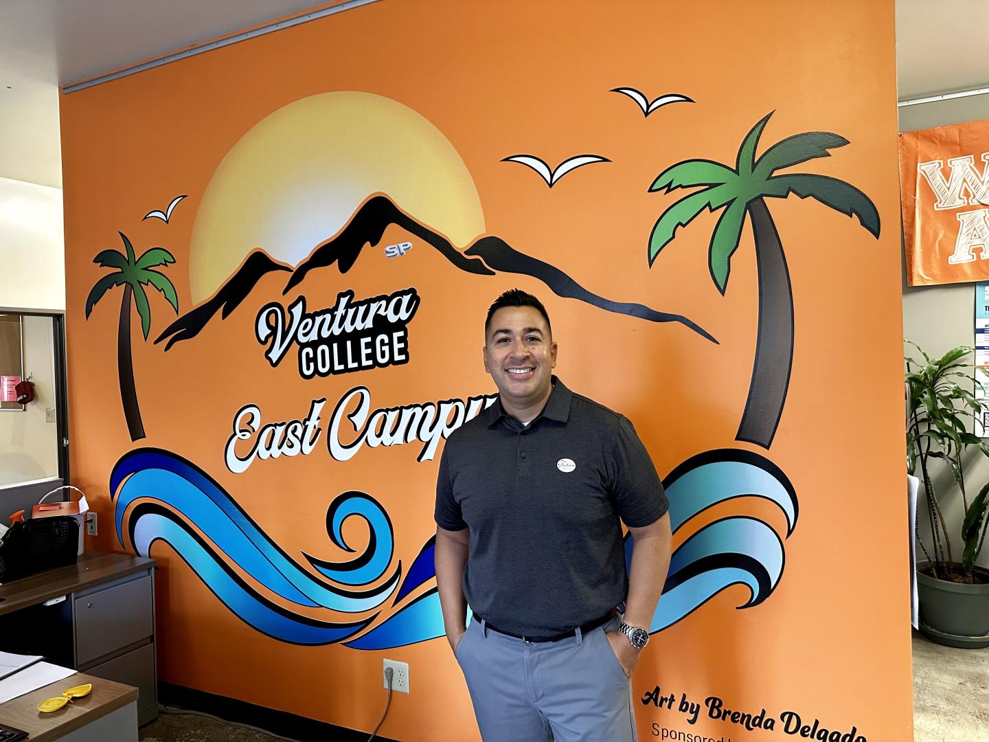 Ed Morales standing in front of wall mural at VCEC