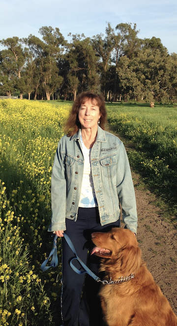 maureen sheldon on a trail with her dog