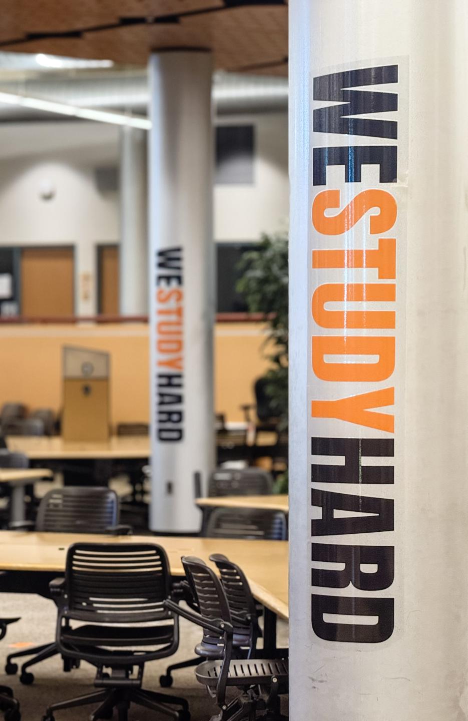 Pillars inside of the Learning Center that read, "WE STUDY HARD."
