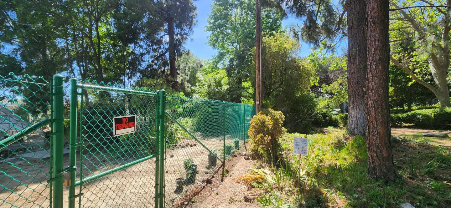Photo is of the new Fence alongside the avocado orchard and the ECT building on campus facing towards the MCE building.