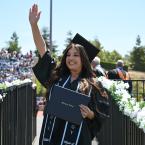 A graduate from Moorpark College wearing a cap and gown with
