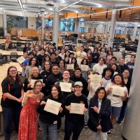 Ventura College Stan Weisel Tutoring Center staff and newly certified CRLA Level One tutors gather in the tutoring center and hold their certification documents.