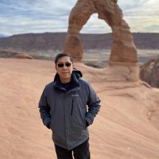 Dr Duan in Arches National Park wearing a grey jacket