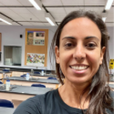 Kammy Algiers smiling in her lab classroom.