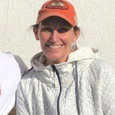 Professor Garner smiling wearing an orange VC cap