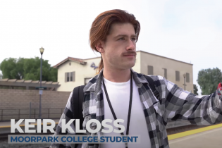 student Keir Kloss looks art bus schedule