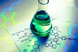 A beaker sitting on top of notes with a molecular diagram.