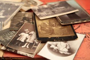 A stack of old sepia toned photographs.