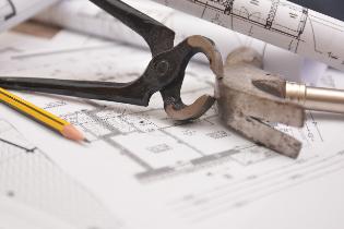 Technical diagram with a hammer, pencils, and other tools.