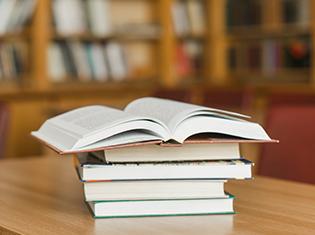 Stack of books on library desk