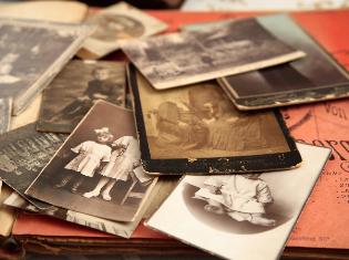 A stack of old sepia toned photographs.