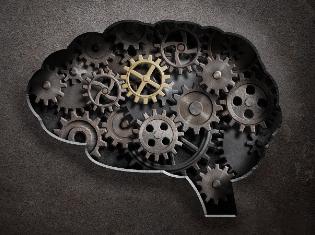 The silhouette of a human brain with cogs and gears filled in.