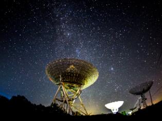 a view of the night sky with satellites in the foreground.