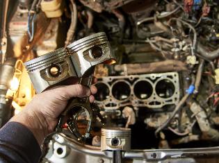 A person working on a diesel engine.