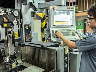 A manufacturing machine being serviced by a technician.