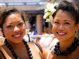 Two women of color in traditional clothing