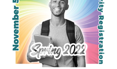 Male college student wearing a backpack and holding laptop w Male college student wearing a backpack and holding laptop w