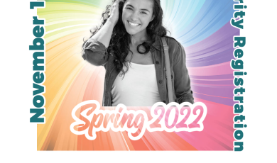 Young female college student looking upward with a rainbow b Young female college student looking upward with a rainbow b