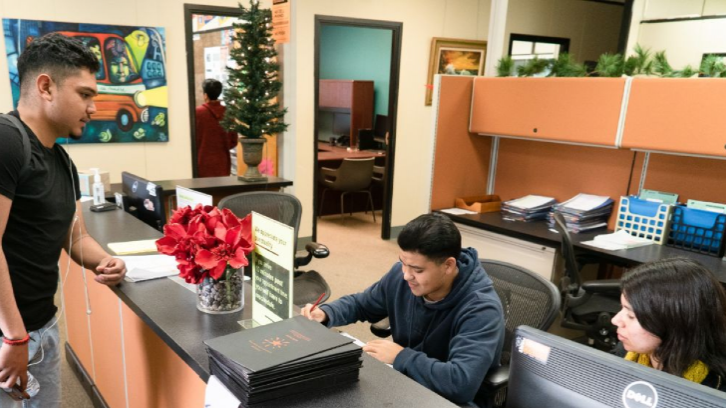 Ventura College Student talking with EOPS Staff inside EOPS office