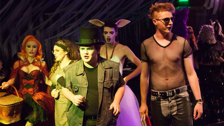 Actors in risque clubwear and animal costumes sing in a production of Into the Woods.