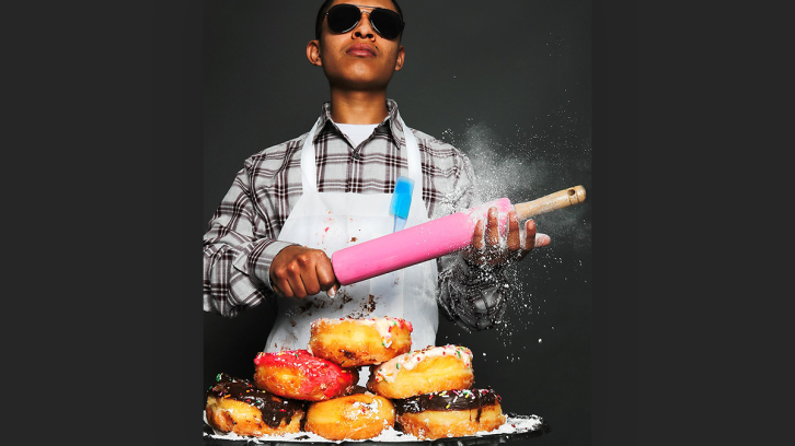 Cool guy with a rolling pin and a plate of donuts