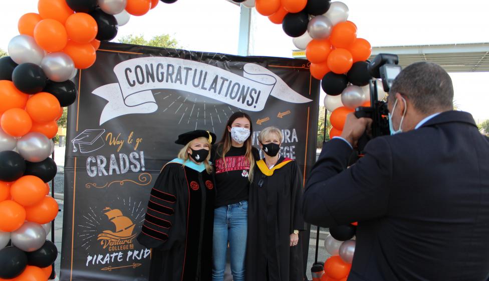 Ventura College Graduate posing with Trustee Dianne McKay and President Kim Hoffmans