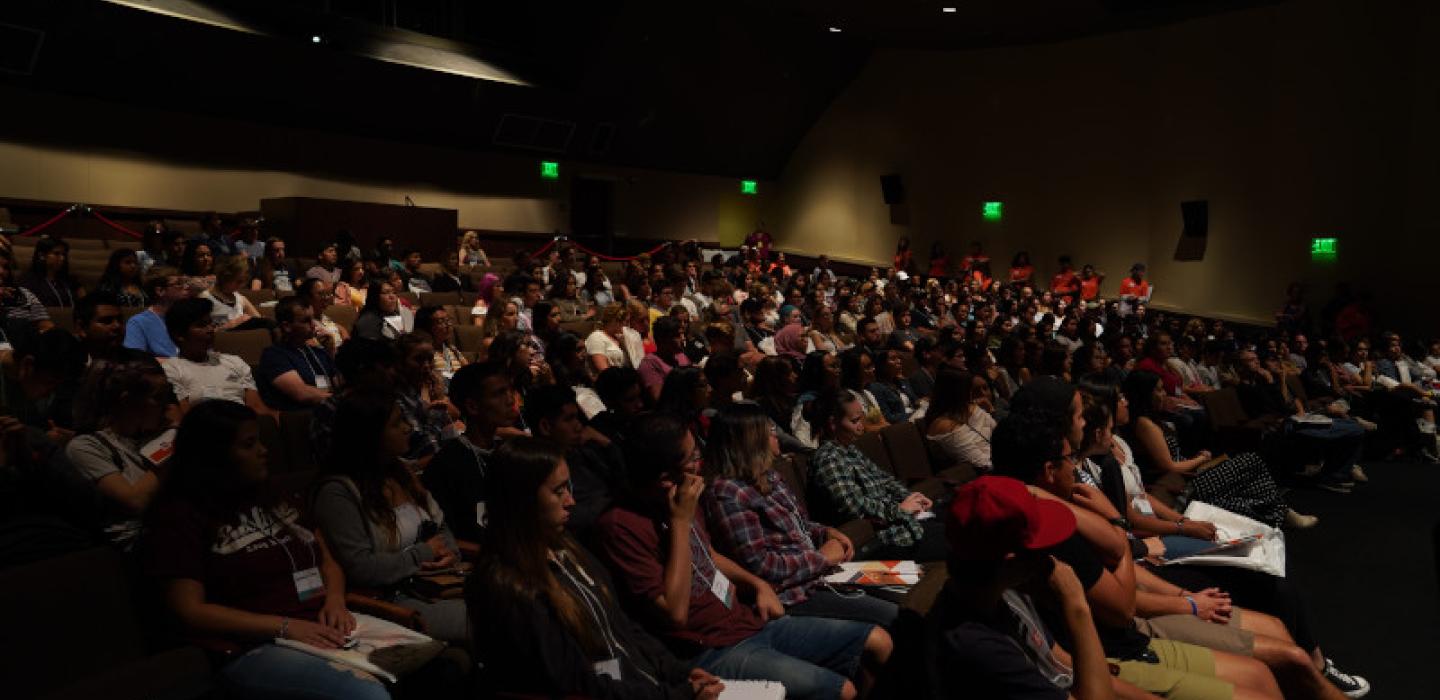 Students siting in the Auditorium viewing the FYE Assembly 