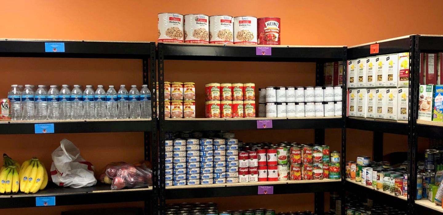 Photo of Racks of Foods and Supplies from the Food Pantry