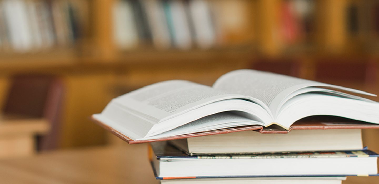 Stack of books on library desk