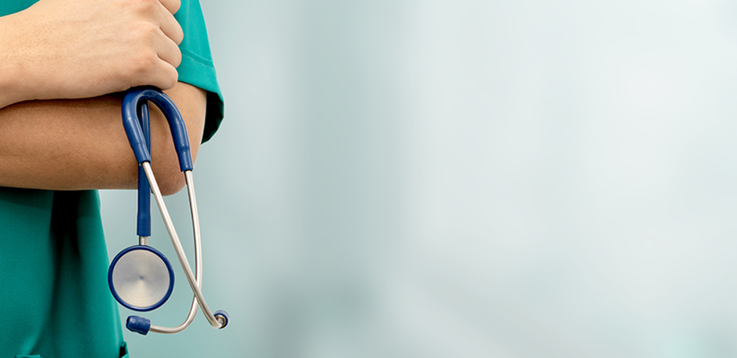 a medical assistant holding a stethoscope.