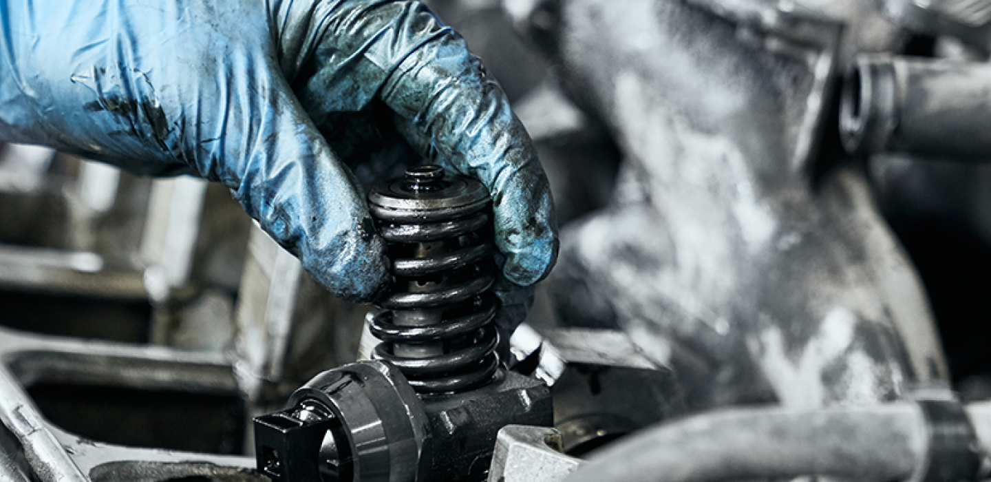 mechanic checking nozzle in diesel car engine