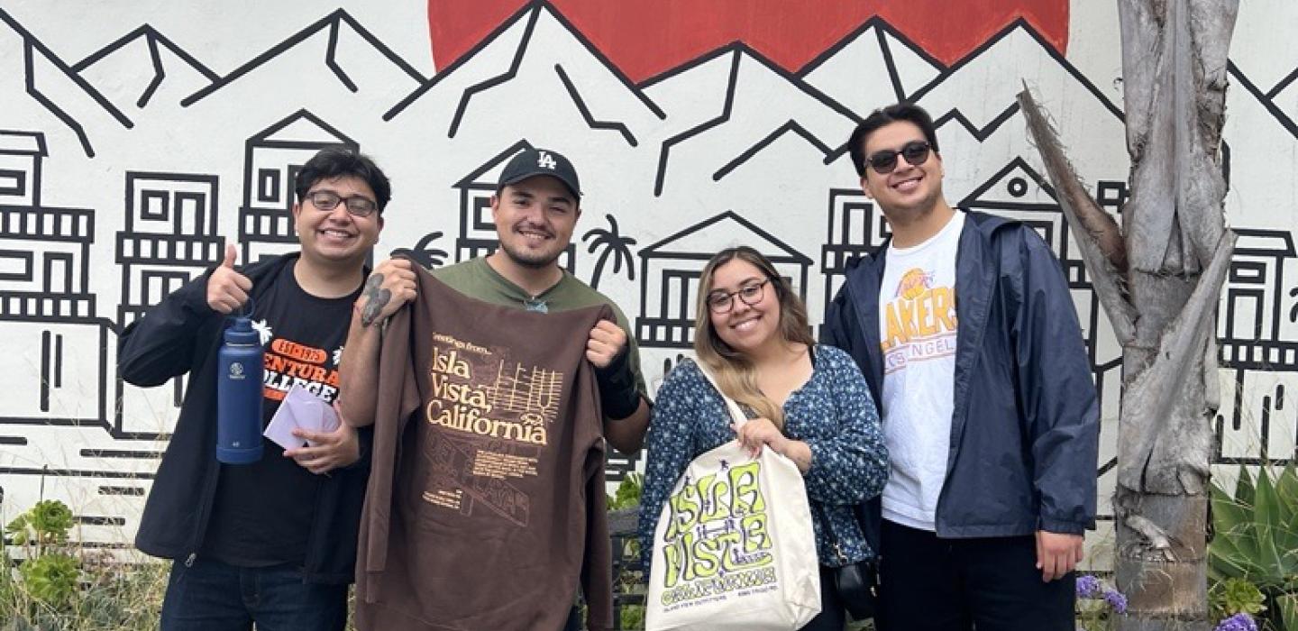 Group photo of Ventura College students in front of a mural at UCSB